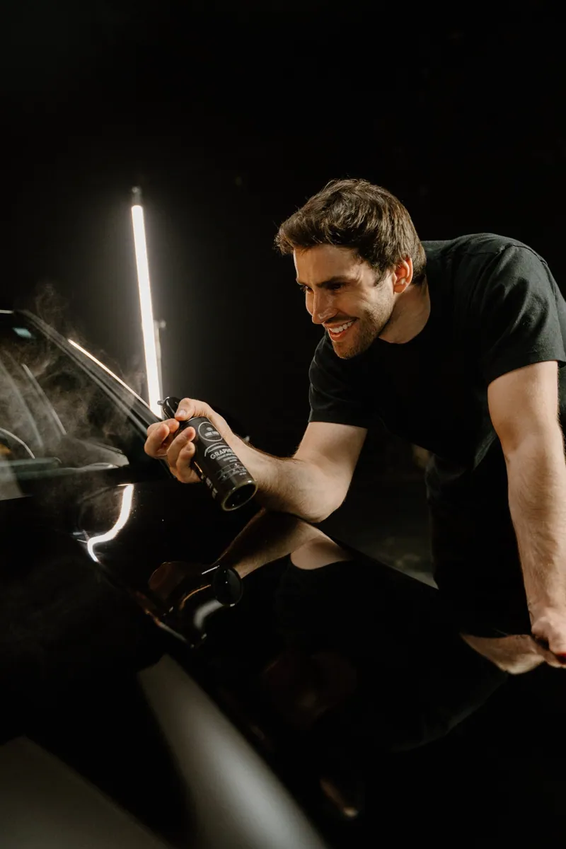 Graphene Ceramic Spray being applied to a vehicle panel indoors